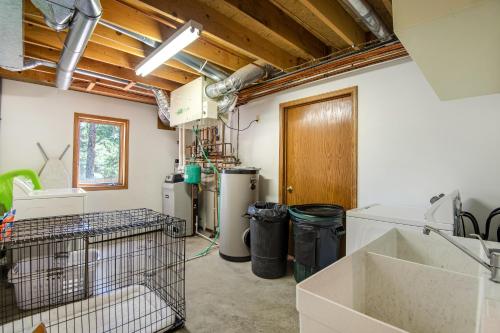 a laundry room with two refrigerators and a sink at Whispering Wind in the Trees - Permit #3504 in Estes Park