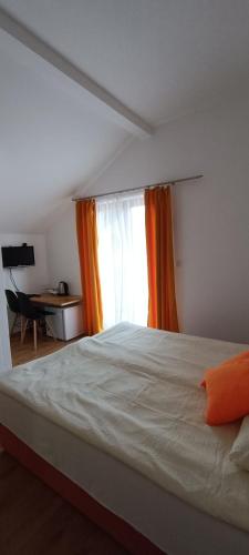 a bedroom with a large bed with a window at Galesic Apartments & Rooms in Korenica