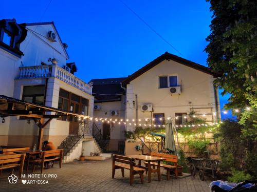 a patio with a table and a string of lights at Pensiunea Buon Gusto Sibiu-motorcyle friendly,city center in Sibiu