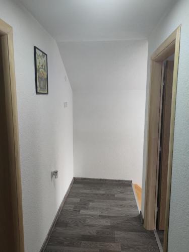 an empty room with a hallway leading to a door at Apartman Amina-Ahmad Vinac-Jajce in Jajce