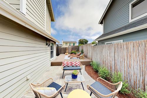 a patio with chairs and tables and a fence at Victorian Dream in Arroyo Grande