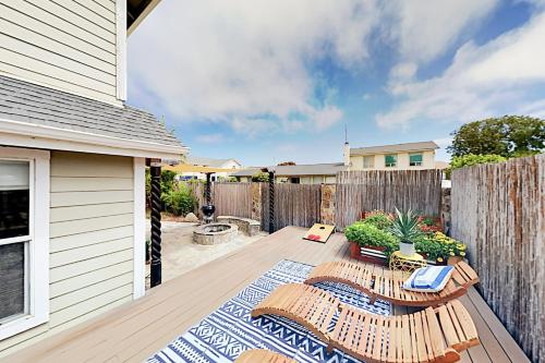 a patio with two chairs and a fence at Victorian Dream in Arroyo Grande
