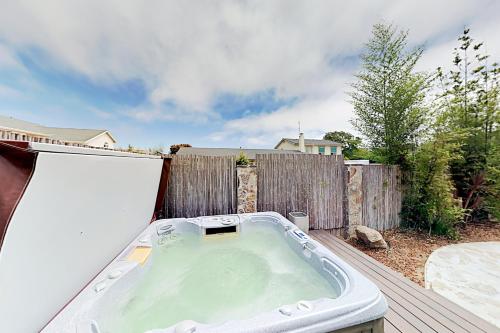 a hot tub on a deck with a fence at Victorian Dream in Arroyo Grande