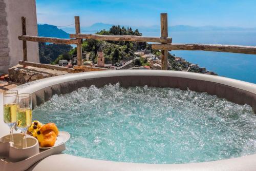 a hot tub on a balcony with a view at Villa Salice in Amalfi
