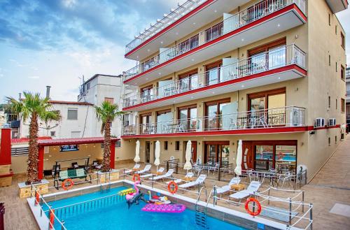 an apartment building with a swimming pool in front of it at RENT HOUSE ANEMOS in Iraklitsa