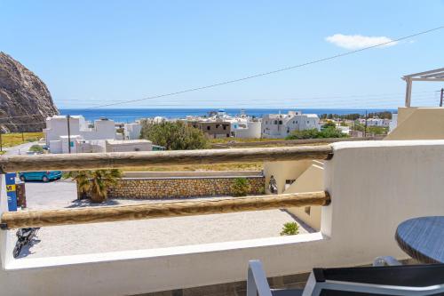 a view from a balcony of a building with a view of the ocean at Marousi Suites in Perissa