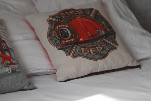 a pillow with a helmet on it on a bed at Bel'air Gare By Carl-Emilie 2 personnes in Épinal