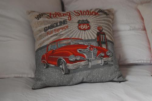 a pillow with a car on it on a bed at Bel'air Gare By Carl-Emilie 2 personnes in Épinal