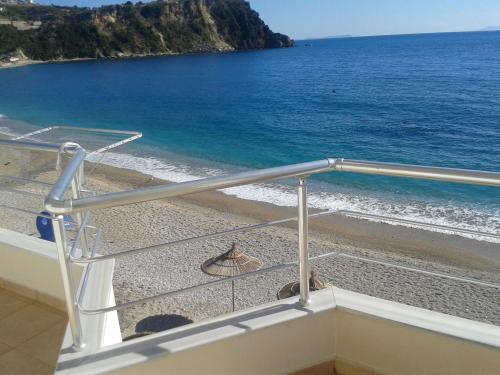 a balcony with a view of the beach at Magic Ionian Apartments & Rooms in Himare