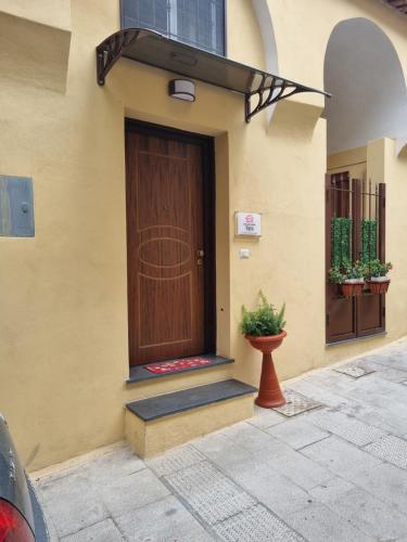 a brown door on the side of a building at Holiday Home Yaya in Scafati