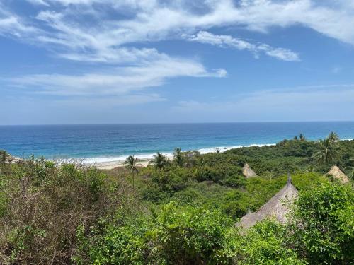 a view of the beach and the ocean at Ecohabs Tequendama - Parque Tayrona in El Zaino