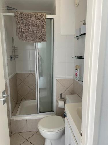 a bathroom with a shower and a toilet and a sink at Ocean View B1001 in Bloubergstrand