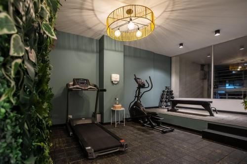 a room with a gym with a treadmill and a phone at 103 Wonderful House in Bogotá