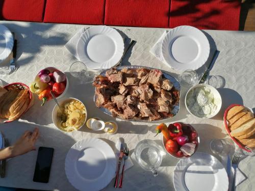 a white table with a plate of food on it at Baranja Black Hill's in Gajić
