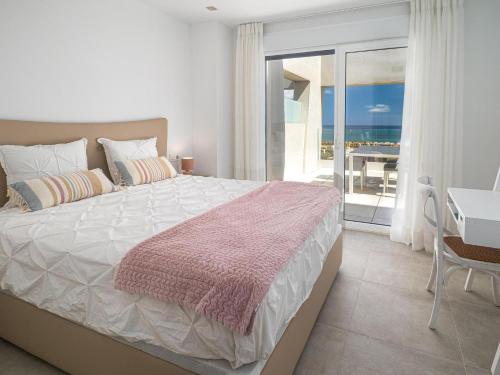 a bedroom with a bed and a view of the ocean at Via Celere 2376 Beach & Golf in San Luis de Sabinillas
