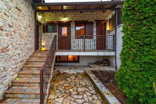 a home with a staircase leading to a balcony at Βίλλα Γαλήνεμα Νο2 in Nóstimon