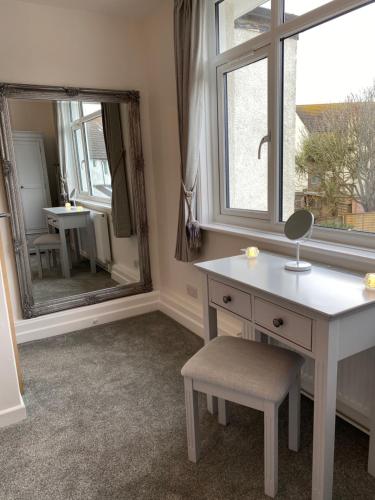 a bathroom with a white vanity and a mirror at WORTHING BEACH 180 - 2 bed seafront apartment with private parking in Worthing