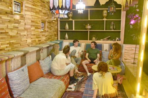 a group of people sitting on a couch in a room at Riad Verus in Fès
