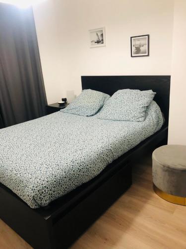 une chambre avec un lit avec un cadre de lit noir dans l'établissement Maison la londe, à La Londe-les-Maures