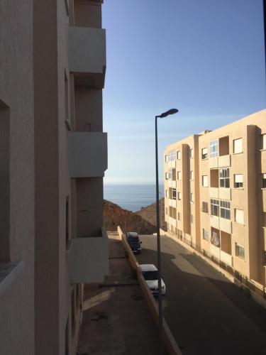 a view of a street with buildings and a street light at Appartement Familial Al Hoceima WiFi in Al Hoceïma