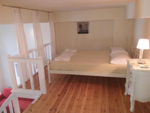Un pat sau paturi într-o cameră la Roula's Suites