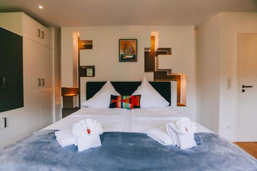 a bedroom with a large bed with white towels at Rieslingresidenz in Traben-Trarbach