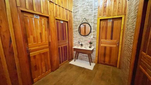 a bathroom with a sink and two wooden doors at Casa hotel in Barra do Guarita