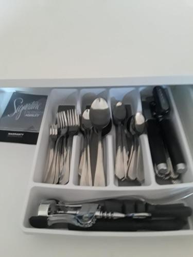 a drawer full of utensils in a container at Retreat by the Beach Lovely New 2 Bedroom in Discovery Bay