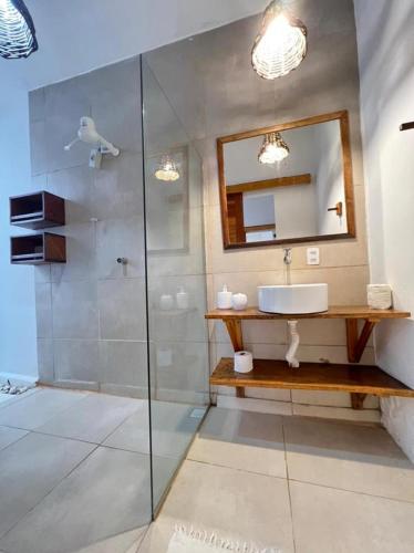 a bathroom with a shower and a sink and a mirror at Villa Mar Residence in Jericoacoara