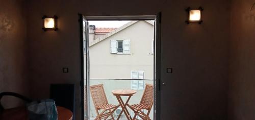a balcony with two chairs and a table in a room at Apartments with sea view in Prcanj in Kotor