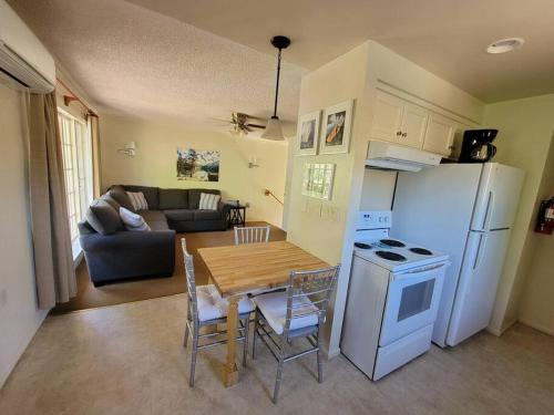 a kitchen and living room with a table and a refrigerator at Becky's Condo in Mariposa