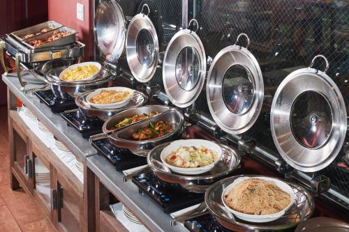 a bunch of dishes of food on a counter at 翠安儂風旅 in Taitung City