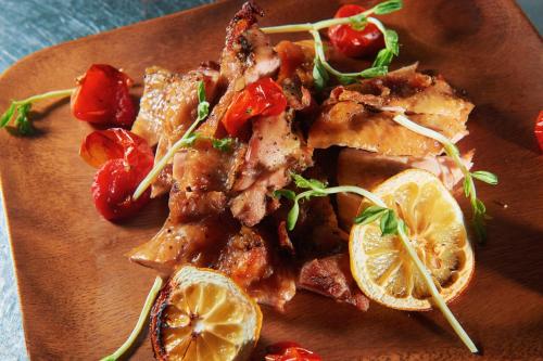 a plate of food with chicken and strawberries and lemons at 翠安儂風旅 in Taitung City