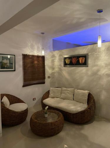 a living room with a couch and a table at Cabañas Luxury con Lagoon Club - Adults Only in Bacalar