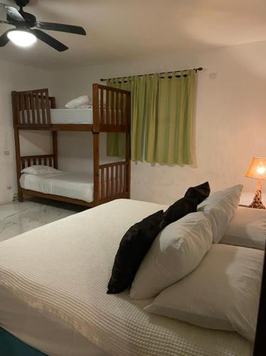 a bedroom with two beds and a ceiling fan at Cabañas Luxury con Lagoon Club - Adults Only in Bacalar