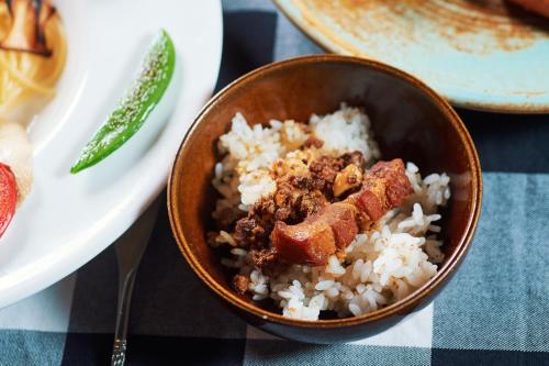 a bowl of rice with meat on top of it at 翠安儂風旅 in Taitung City