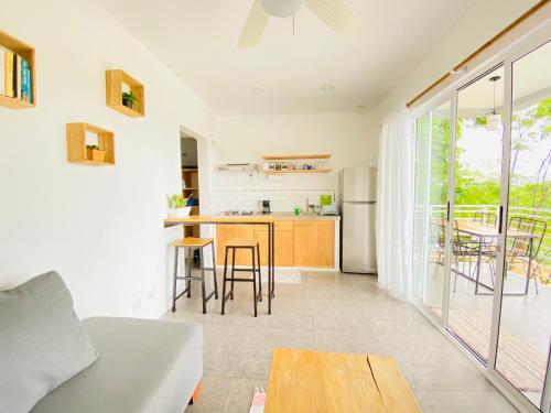 a kitchen and living room with a couch and a table at Altamar in Santa Teresa Beach