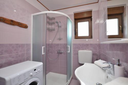 a bathroom with a shower and a toilet and a sink at House Pobri in Opatija