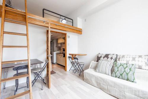 a living room with a couch and a bunk bed at HIDEOUT in Sapporo