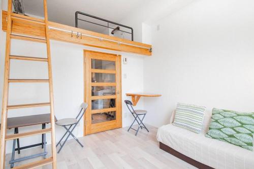 a living room with a bunk bed and a couch at HIDEOUT in Sapporo