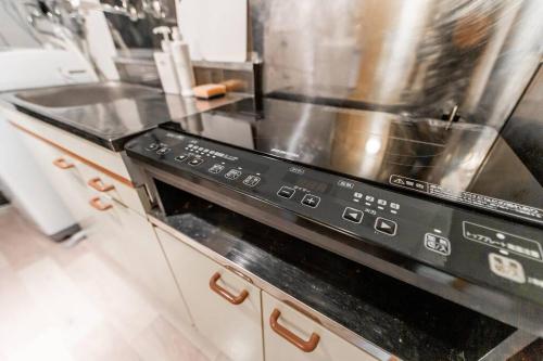 a kitchen with a black stove top oven at HIDEOUT in Sapporo