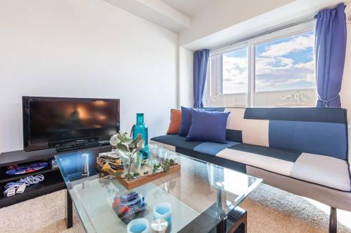 a living room with a couch and a tv at GRAVITY in Sapporo