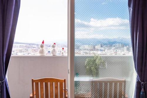 a room with a window with a view of a city at GRAVITY in Sapporo