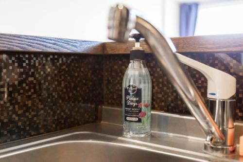 a bottle of dish soap sitting on top of a sink at GRAVITY in Sapporo