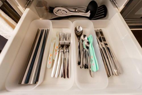 a white tray with forks and spoons and utensils at GRAVITY in Sapporo