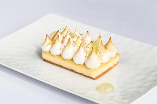 a white plate with a dessert with whipped cream at InterContinental Bordeaux Le Grand Hotel by IHG in Bordeaux