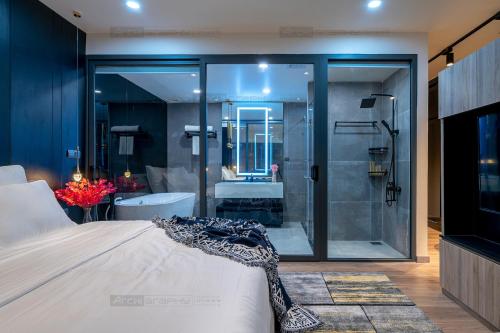 a bedroom with a bathroom with a shower and a bed at ELITE HOME in Tuy Hoa