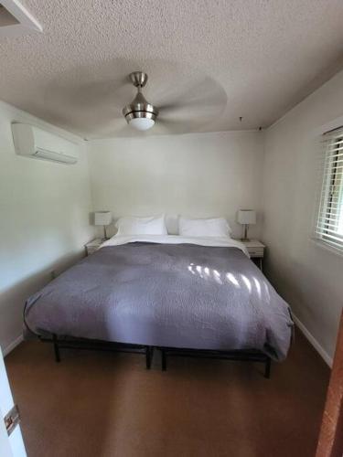 a bedroom with a bed with a ceiling fan at Becky's Condo in Mariposa