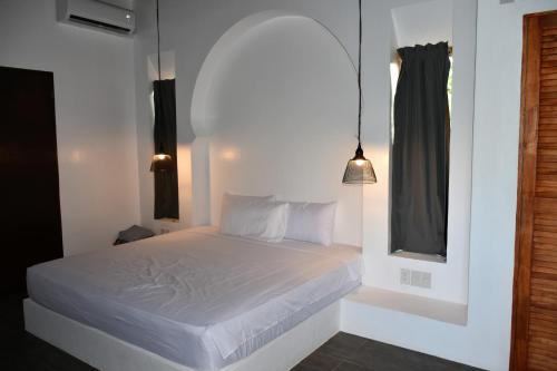 Säng eller sängar i ett rum på Balai Cinta