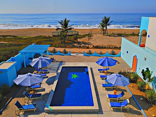 an aerial view of a resort with a swimming pool and umbrellas at Villa Star of the Sea in Barra de Navidad